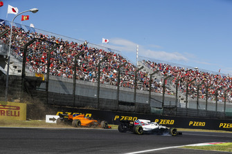 Fernando Alonso, McLaren MCL33, runs off the track behind Lance Stroll, Williams FW41