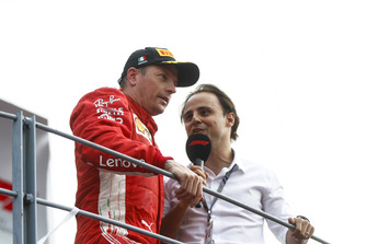 Kimi Raikkonen, Ferrari, second position, is interviewed by Felipe Massa on the podium