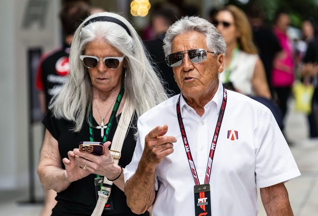 Mario Andretti looks on in the Paddock 