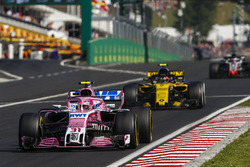Esteban Ocon, Force India VJM11, leads Carlos Sainz Jr., Renault Sport F1 Team R.S. 18, and Romain Grosjean, Haas F1 Team VF-18