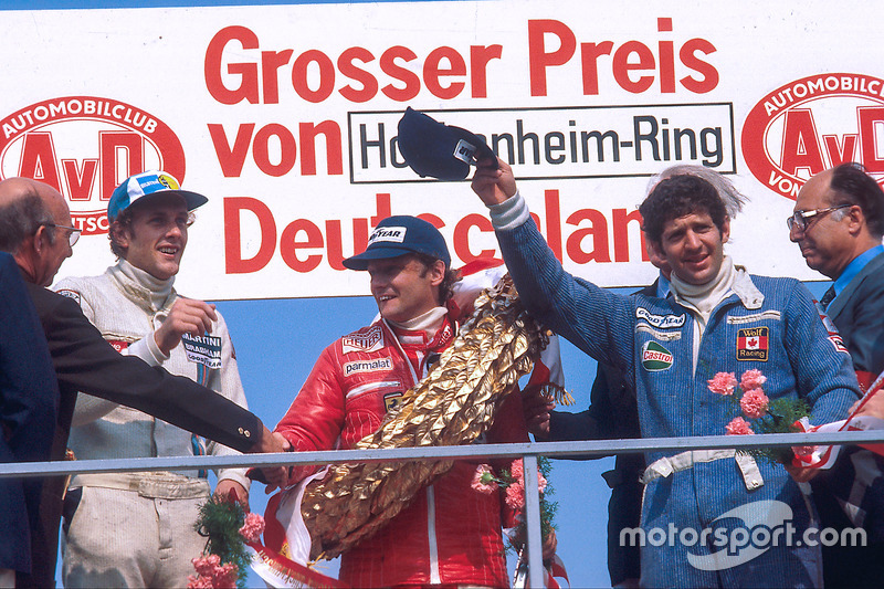 Niki Lauda, 1st position, Jody Scheckter, 2nd position and Hans-Joachim Stuck, 3rd position on the podium