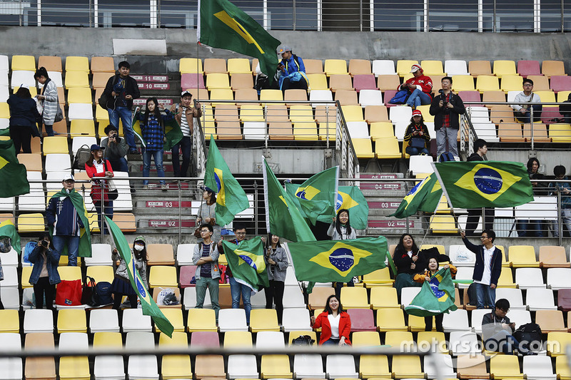 Chinese fans wave Brazilian flags