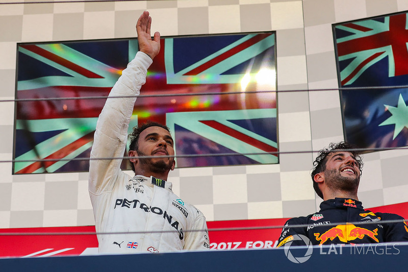 Race winner Lewis Hamilton, Mercedes AMG F1 celebrates on the podium alongside Daniel Ricciardo, Red Bull Racing
