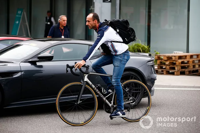 Robert Kubica, Williams Racing, arrives in the paddock on a bike