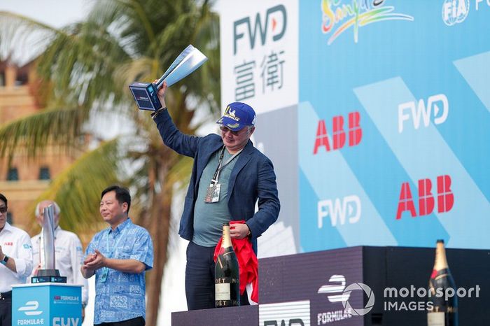 A DS TECHEETAH representative on the podium with the winner's trophy