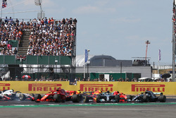 Sebastian Vettel, Ferrari SF71H leads as Kimi Raikkonen, Ferrari SF71H and Lewis Hamilton, Mercedes-AMG F1 W09 collide at the start of the race