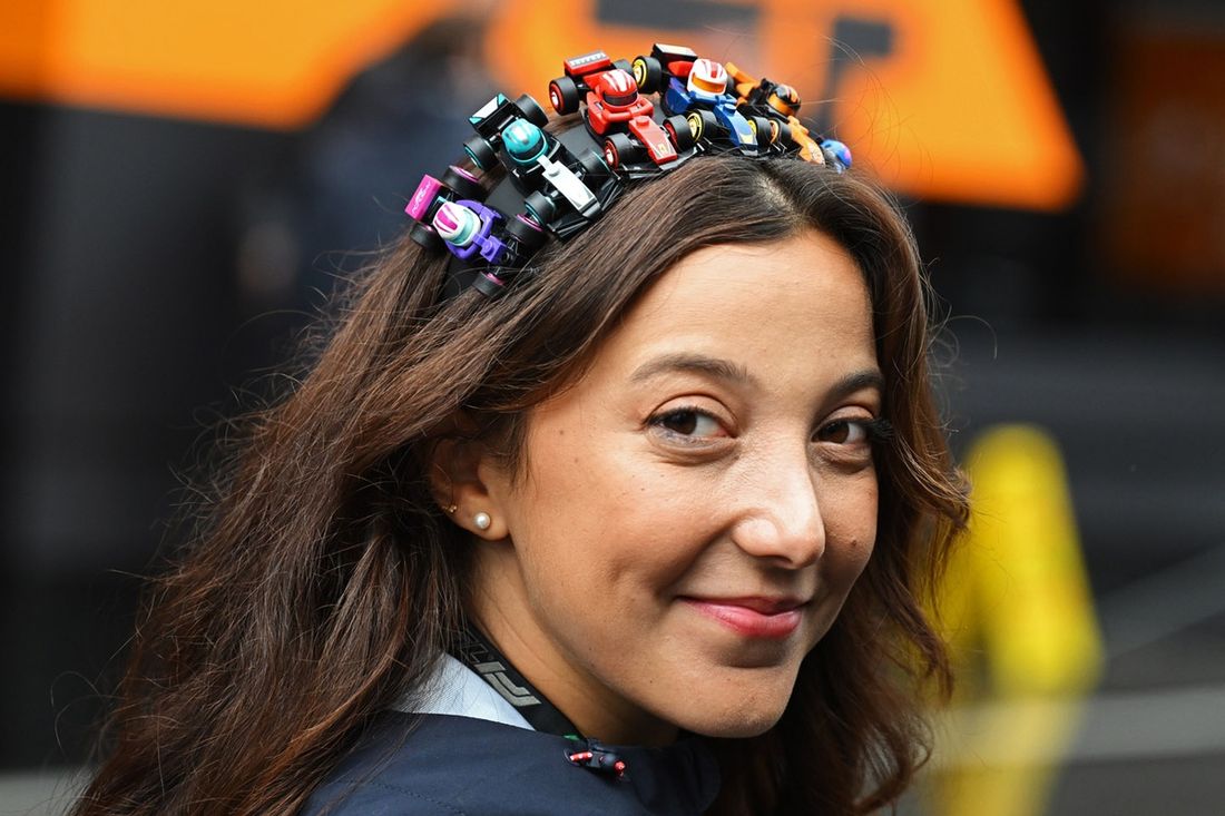 A fan wears a headband made of LEGO F1 cars