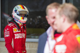 Sebastian Vettel, Ferrari, looks over as Kimi Raikkonen, Ferrari, 1st position, is interviewed by Martin Brundle, Sky Sports F1.