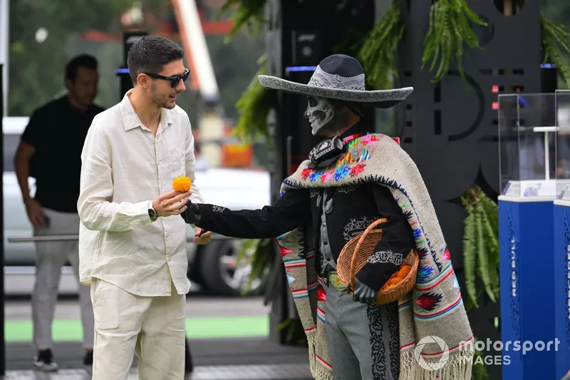 Esteban Ocon, Alpine F1 Team, is handed a Mexican marigold 