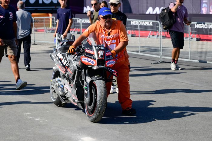 A crashed Factory Racing Aprilia is pushed back to the paddock.