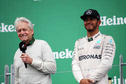 (L to R): Michael Douglas, Actor on the podium with race winner Lewis Hamilton, Mercedes AMG F1