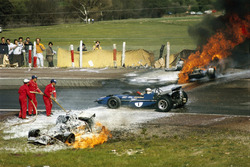 Jackie Oliver's BRM collided with Jacky Ickx's Ferrari. Jackie Stewart is passing the scene of accident