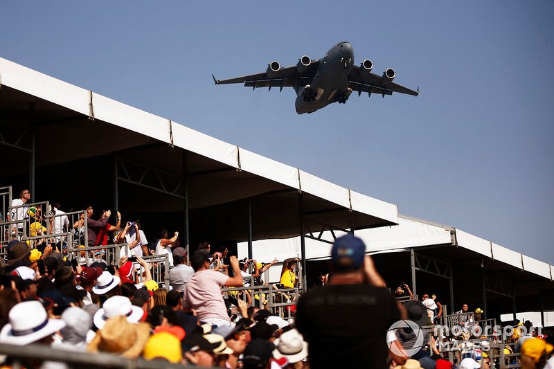 A Boeing C-17A Globemaster III of the Royal Australian Air Force flies over the grid prior to the start