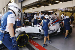 Les mécaniciens placent la voiture de Lance Stroll, Williams FW40 dans son garage à côté de Felipe Massa, Williams