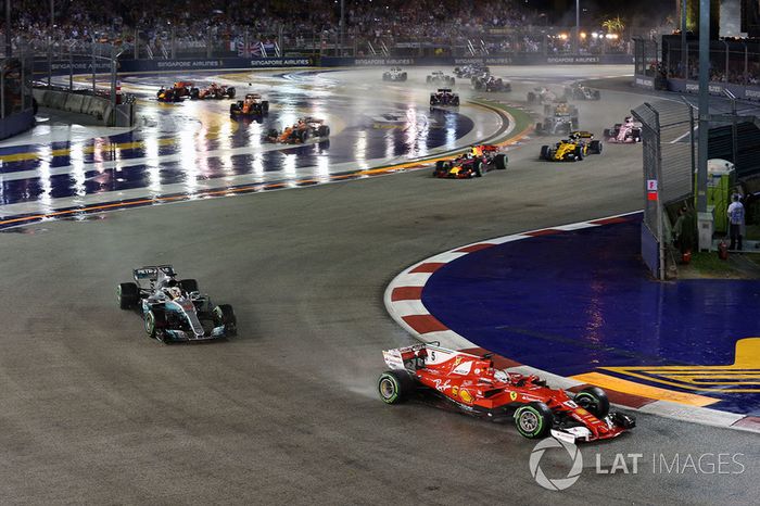 Sebastian Vettel, Ferrari SF70H leads at the start of the race and the cars of Kimi Raikkonen, Ferrari SF70H and Max Verstappen, Red Bull Racing RB13 crash after colliding