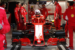 Kimi Raikkonen, Ferrari, enters his cockpit