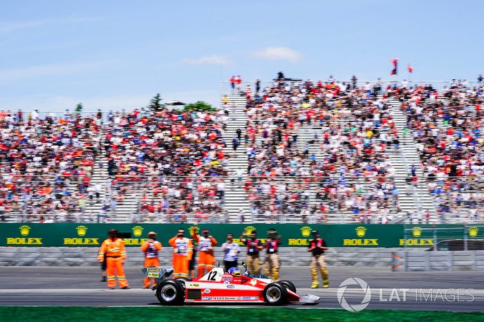 Jacques Villeneuve drives the Ferrari 312T3 raced by his father Gilles Villeneuve on a parade lap