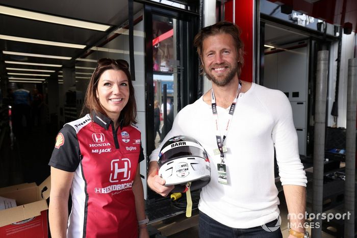 Actor Matt Barr poses for a photo with Katherine Legge at Rahal Letterman Lanigan Racing transporter