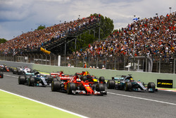 Sebastian Vettel, Ferrari SF70H, Lewis Hamilton, Mercedes AMG F1 W08, lead the field away at the start