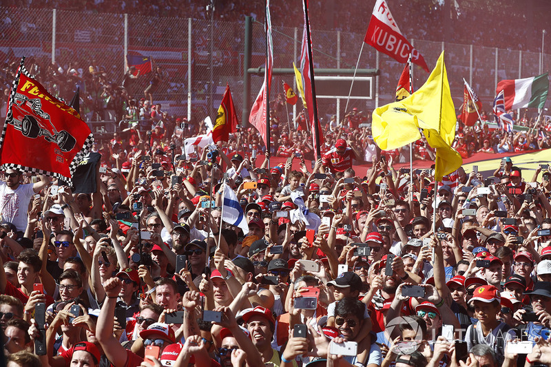 A throng of Ferrari fans invade the circuit after the race