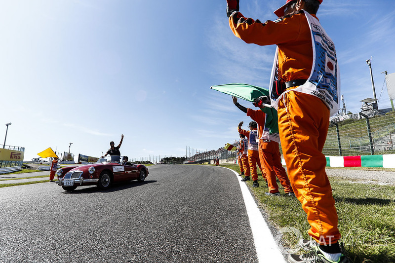 Marshals line the track as Daniel Ricciardo, Red Bull Racing, passes in the drivers parade