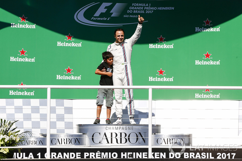 Felipe Massa, Williams, waves to the fans from the podium with his son Filipinho