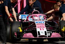 Sergio Perez, Force India, is wheeled into his pit garage by mechanics