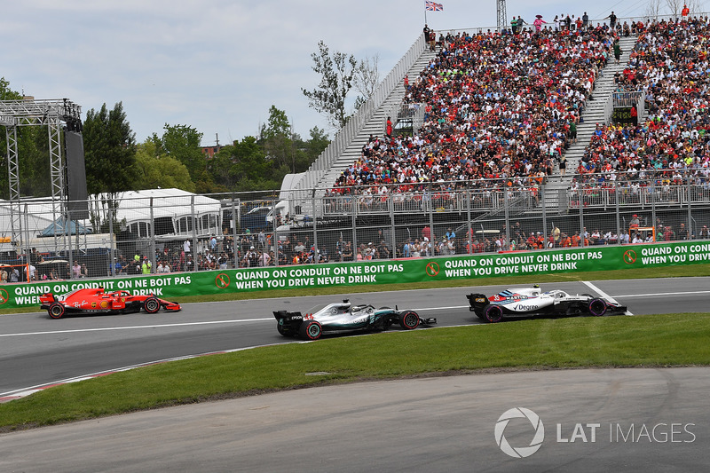 Kimi Raikkonen, Ferrari SF71H exits pit lane behind Lewis Hamilton, Mercedes-AMG F1 W09
