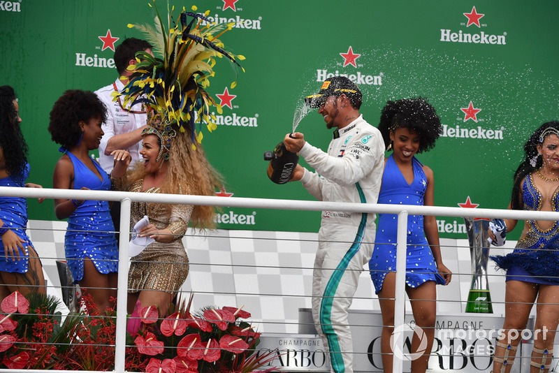 Race winner Lewis Hamilton, Mercedes AMG F1 celebrates on the podium with Andy Shovlin, Mercedes-AMG F1 Chief Engineer and the samba girls and the champagne 