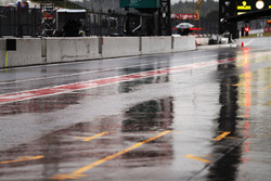 Rain falls in the pit lane