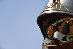 Romain Grosjean, Haas F1 Team VF-18 reflected in a fireman helmet