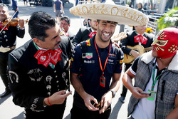Daniel Ricciardo, Red Bull Racing, dons a sombrero, next to locals in traditional costume