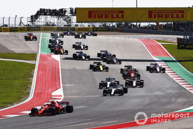 Kimi Raikkonen, Ferrari SF71H, leads Lewis Hamilton, Mercedes AMG F1 W09 EQ Power+, at the start of the race