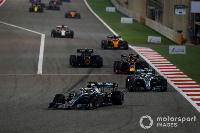 Lewis Hamilton, Mercedes AMG F1 W10, leads Valtteri Bottas, Mercedes AMG W10, Max Verstappen, Red Bull Racing RB15, Kevin Magnussen, Haas F1 Team VF-19, and the remainder of the field at the start