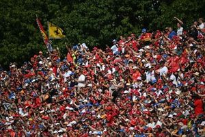 Fans fill a grandstand with red in support of Ferrari during the F1 Grand Prix of Italy.
