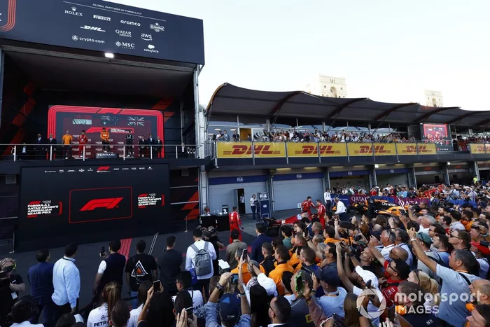 Los miembros del equipo observan a Oscar Piastri, McLaren F1 Team, 1ª posición, Charles Leclerc, Scuderia Ferrari, 2ª posición, George Russell, Mercedes-AMG F1 Team, 3ª posición, Tom Stallard, Ingeniero de Carrera, McLaren F1 Team.