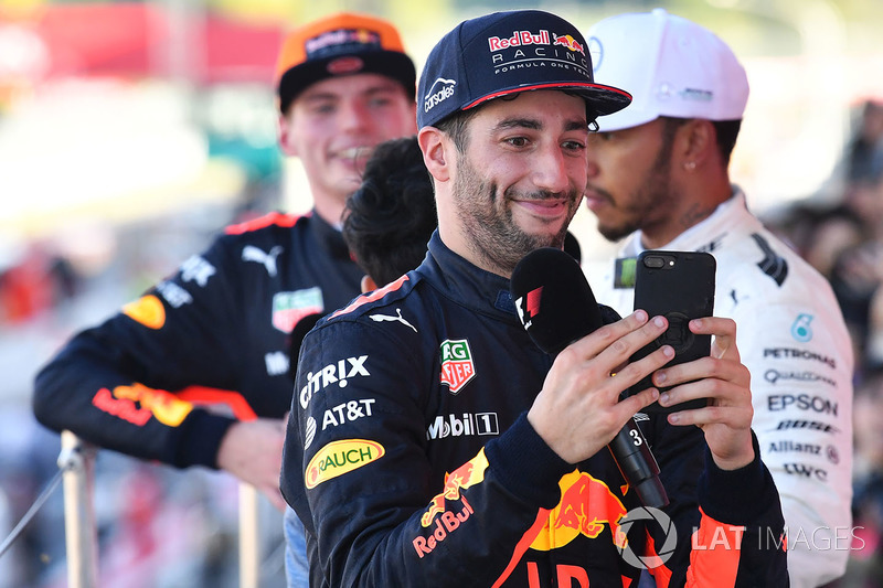 Daniel Ricciardo, Red Bull Racing celebrates with his phone on the podium