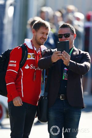 Sebastian Vettel, Ferrari, takes a picture with a fan