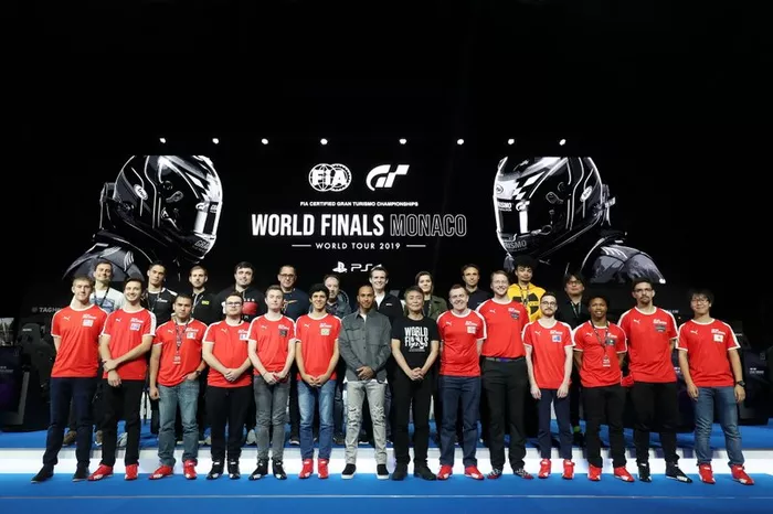 Lewis Hamilton and Kazunori Yamauchi pose for a photograph with competitors prior to the Pro-Am race on November 22, 2019 in Monte-Carlo, Monaco. (Photo by Jack Thomas  - Gran Turismo/Gran Turismo via Getty Images)