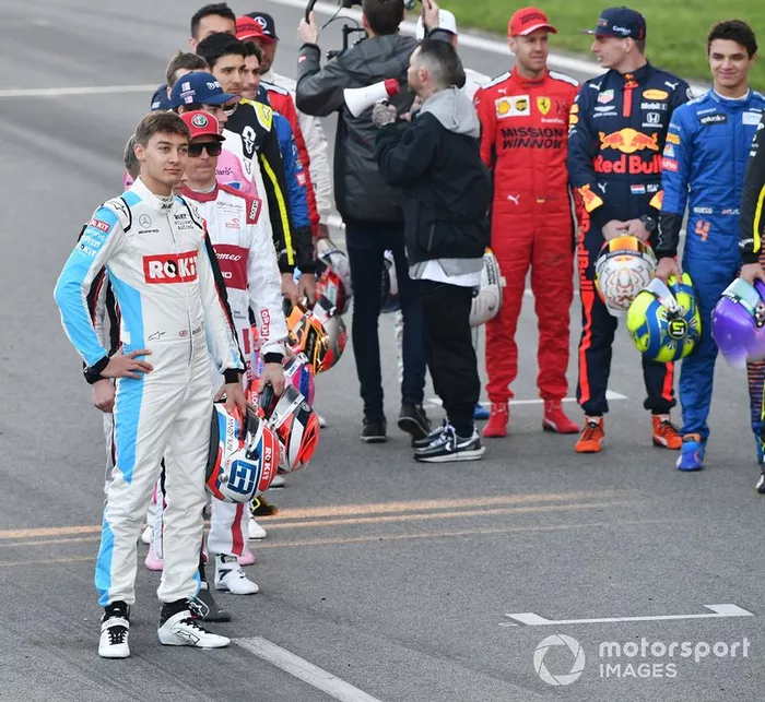 The drivers line up on the track