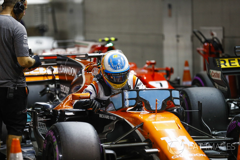 Fernando Alonso, McLaren, climbs out of his car in Parc Ferme