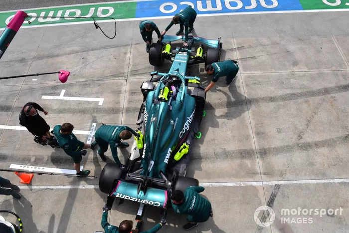 Sebastian Vettel, Aston Martin AMR21, is returned to the garage