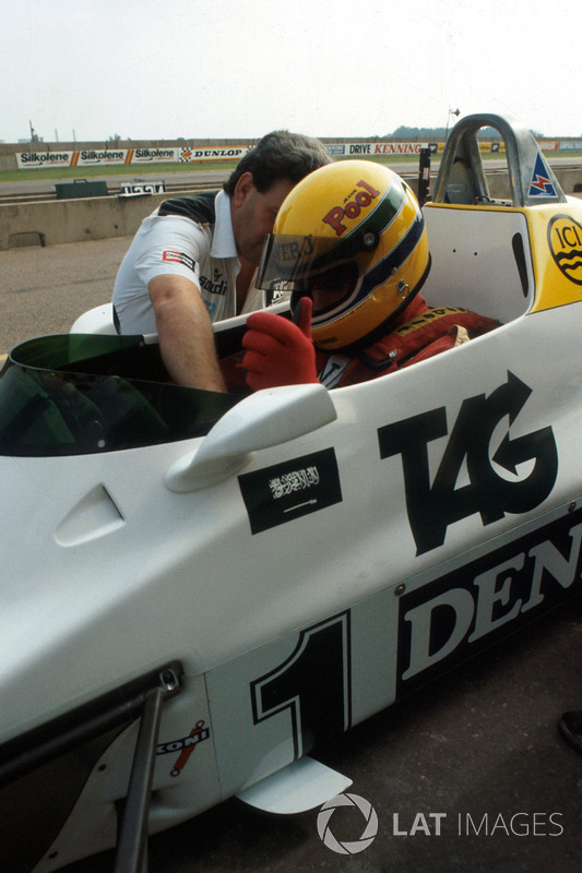 Ayrton Senna, is helped made comfortable by the Williams Team Manager Allan Challis prior to his first run in the Williams FW08C