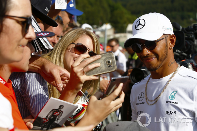 Lewis Hamilton, Mercedes AMG F1, poses for a fan to take a photo