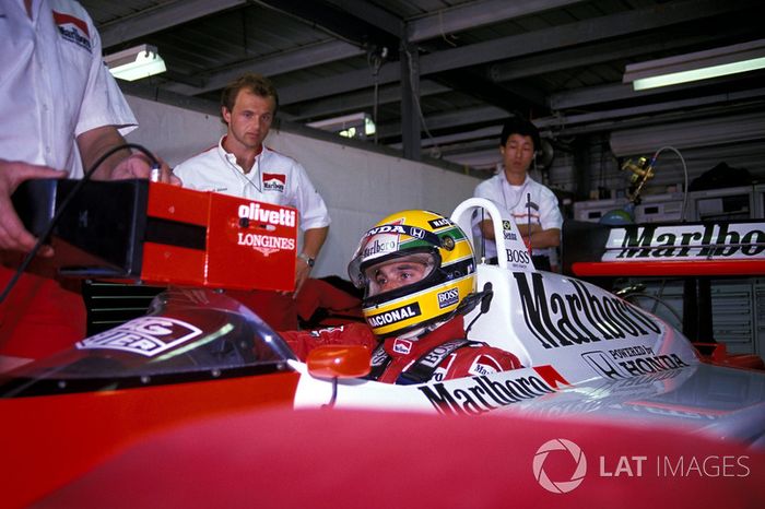 Josef Leberer, McLaren Physio keeps an eye on Ayrton Senna, McLaren as he sits in the cockpit of his car