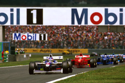 Jacques Villeneuve, Williams FW19 Renault; Michael Schumacher, Ferrari F310B; Olivier Panis, Prost J