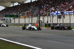 Jenson Button, McLaren MP4-31 and Felipe Massa, Williams FW38 battle for position