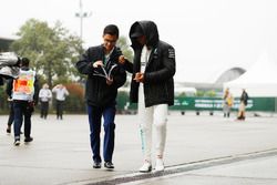 Lewis Hamilton, Mercedes AMG, signs an autograph for a fan