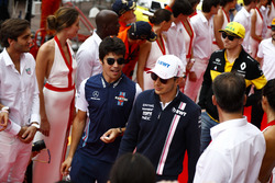 Lance Stroll, Williams Racing, Esteban Ocon, Force India, and Nico Hulkenberg, Renault Sport F1 Team, walk between Tag Heuer promotional models