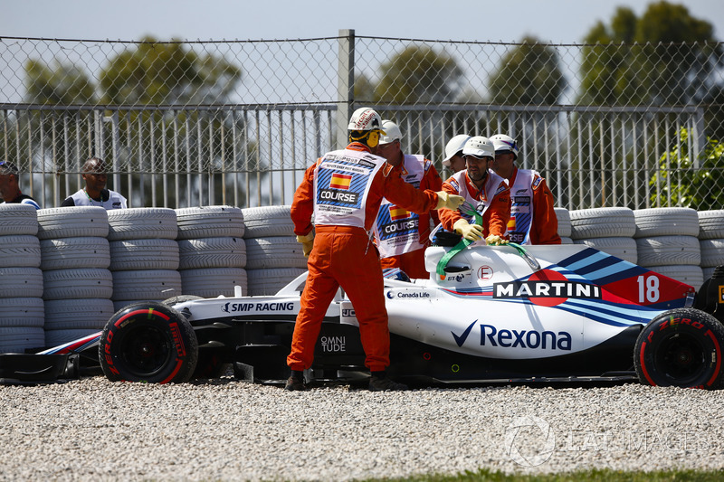 Lance Stroll, Williams FW41, is assisted by marshals after driving into the gravel in FP1